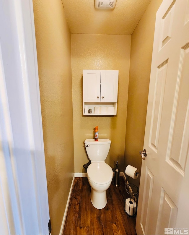 bathroom featuring toilet and hardwood / wood-style flooring