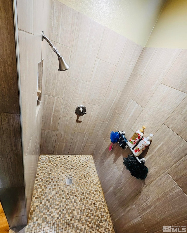 bathroom with tiled shower