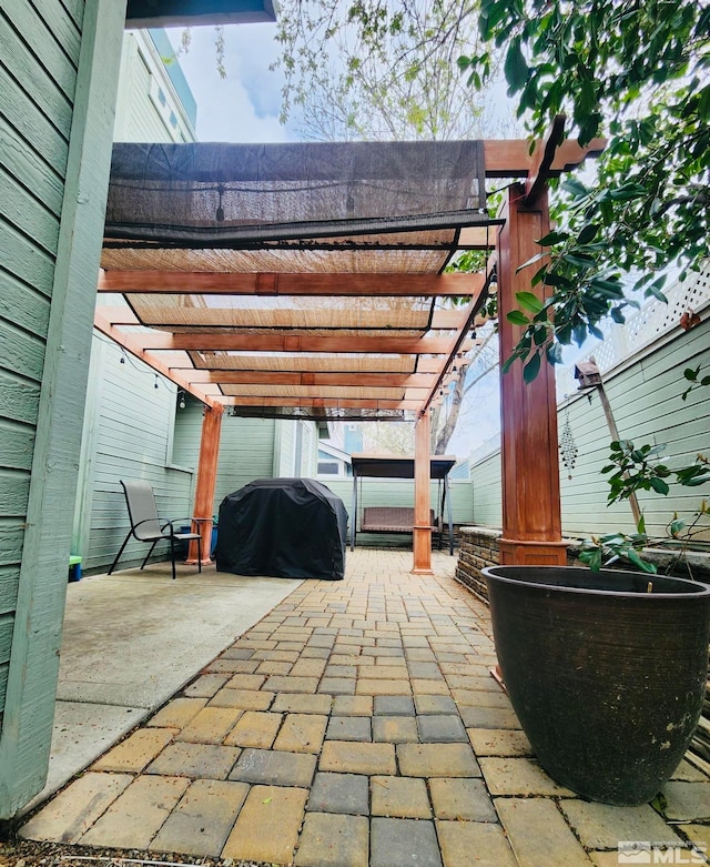 view of terrace with a grill and a pergola