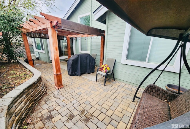 view of patio featuring a pergola and a grill