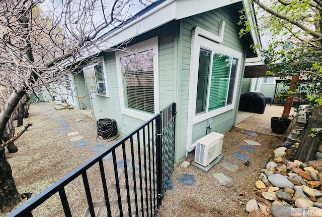 view of side of property featuring central air condition unit and a patio area