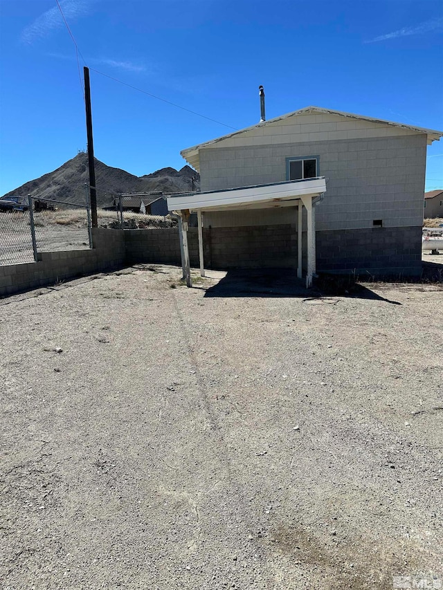 rear view of house featuring a mountain view