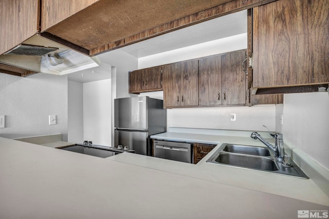 kitchen featuring stainless steel appliances, sink, and custom exhaust hood