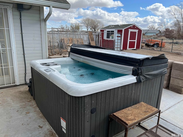 exterior space with a shed and a hot tub