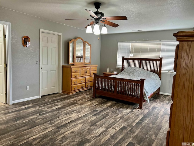 bedroom with a textured ceiling, ceiling fan, and wood-type flooring