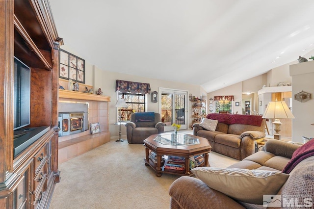 living room featuring a fireplace, vaulted ceiling, and light carpet