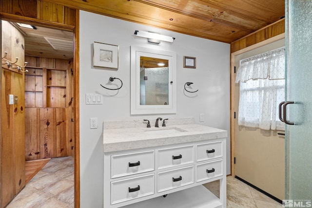 bathroom featuring wooden ceiling, tile patterned floors, wooden walls, a shower with door, and vanity