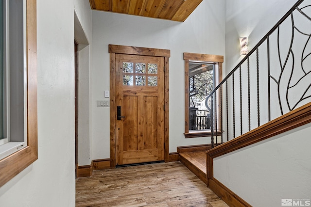 foyer entrance with wooden ceiling and light hardwood / wood-style flooring