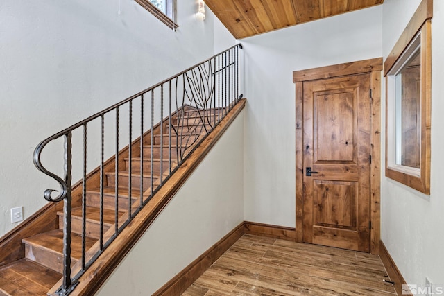 entrance foyer featuring light hardwood / wood-style floors and wooden ceiling