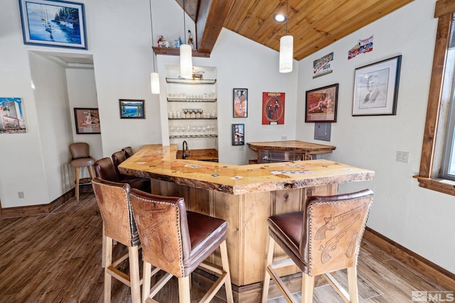 bar with butcher block counters, wooden ceiling, decorative light fixtures, and hardwood / wood-style flooring