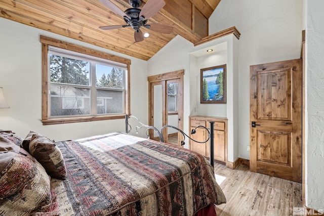 bedroom featuring light hardwood / wood-style flooring, vaulted ceiling, ceiling fan, and wooden ceiling