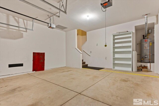 garage with a garage door opener and secured water heater