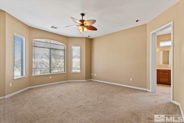 carpeted spare room with ceiling fan