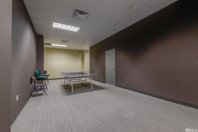 playroom featuring light colored carpet and a paneled ceiling