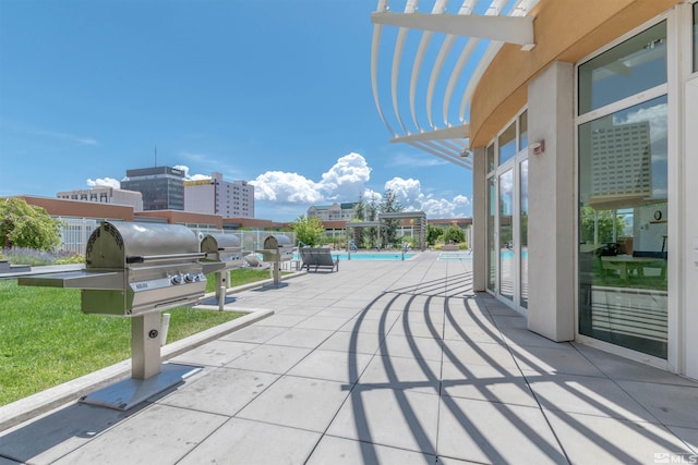 view of terrace with a pergola, grilling area, and a community pool