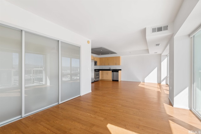 unfurnished living room featuring light hardwood / wood-style flooring