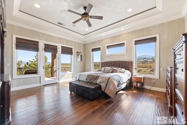 bedroom featuring dark wood-type flooring, access to outside, and multiple windows