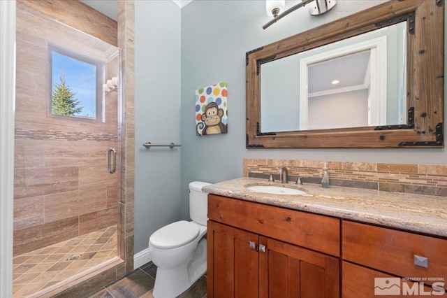 bathroom with backsplash, a shower with shower door, toilet, tile flooring, and vanity