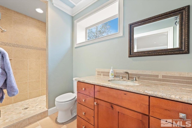 bathroom with vanity, tiled shower, tile floors, and toilet