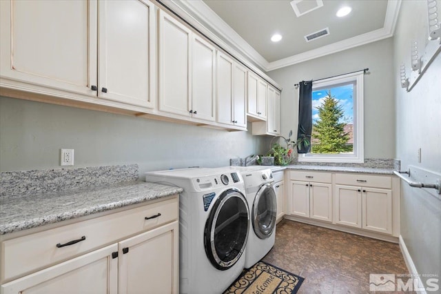 laundry area featuring cabinets, ornamental molding, independent washer and dryer, and dark tile floors