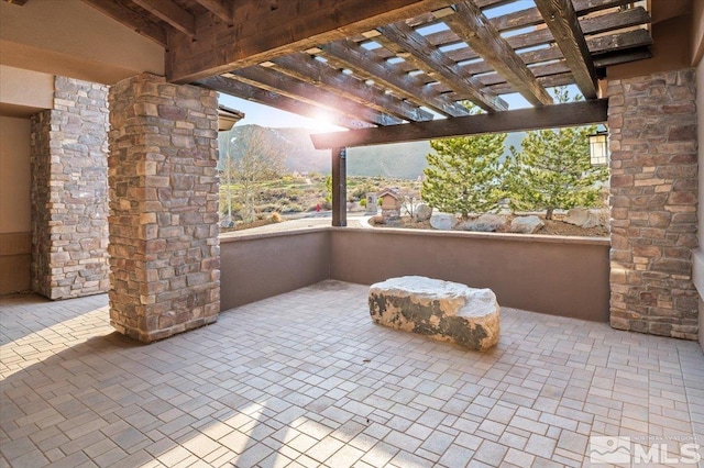 view of terrace with a mountain view and a pergola