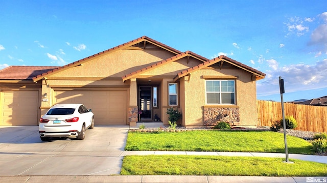 view of front of property with a garage and a front lawn