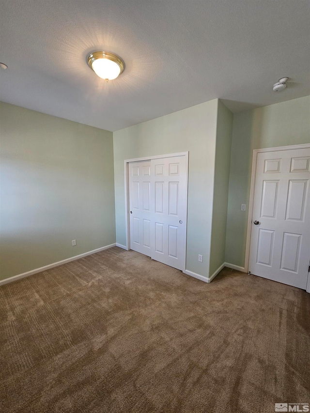 unfurnished bedroom featuring a closet and carpet floors