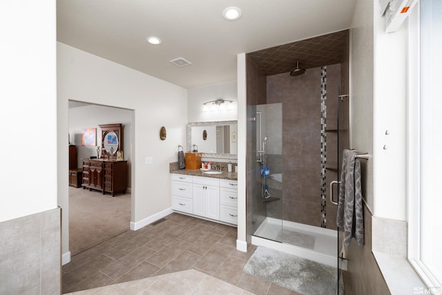 bathroom featuring tile floors, an enclosed shower, and vanity