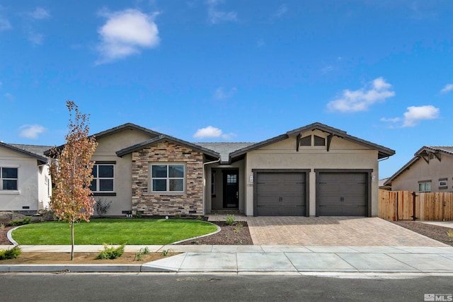 single story home with a garage and a front lawn