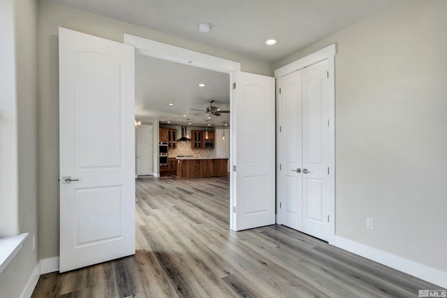 empty room with wood-type flooring and ceiling fan