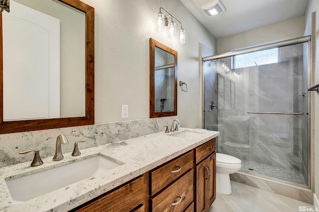 bathroom featuring tile flooring, double sink vanity, toilet, and walk in shower