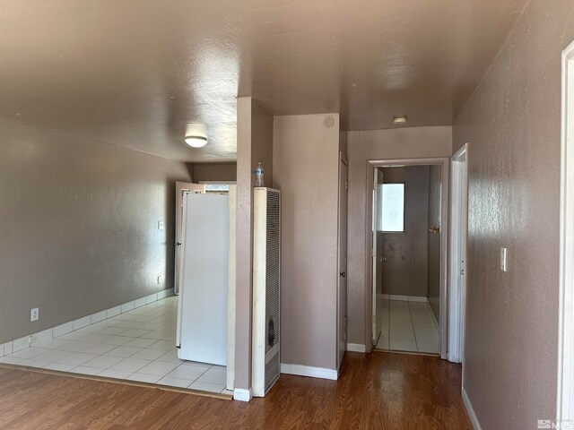 hallway with hardwood / wood-style floors