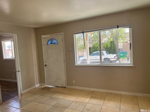 tiled foyer entrance featuring a healthy amount of sunlight