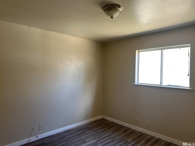 unfurnished room featuring dark hardwood / wood-style floors