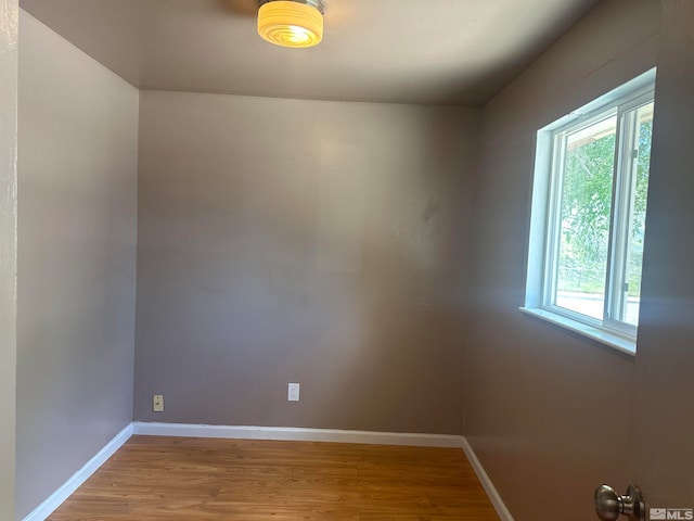 spare room with hardwood / wood-style flooring