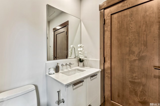 bathroom featuring toilet and oversized vanity