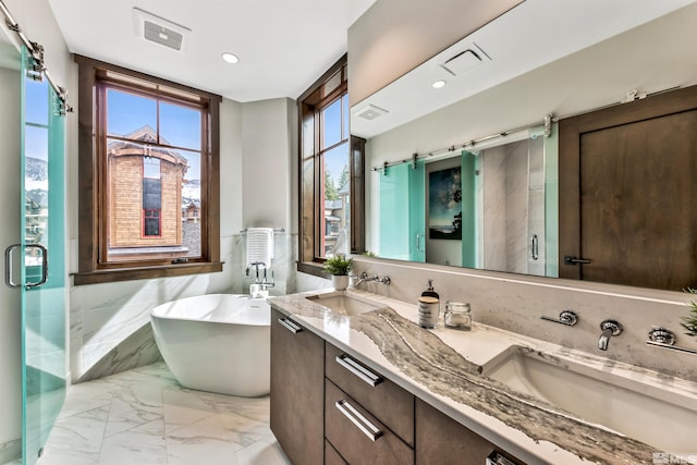 bathroom with double vanity, tile walls, separate shower and tub, and tile floors