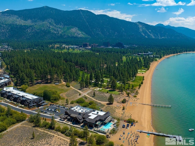 drone / aerial view featuring a water and mountain view