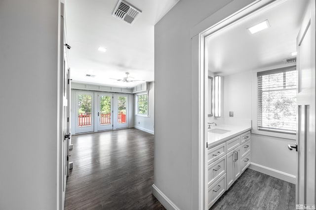 hallway featuring sink and dark hardwood / wood-style floors