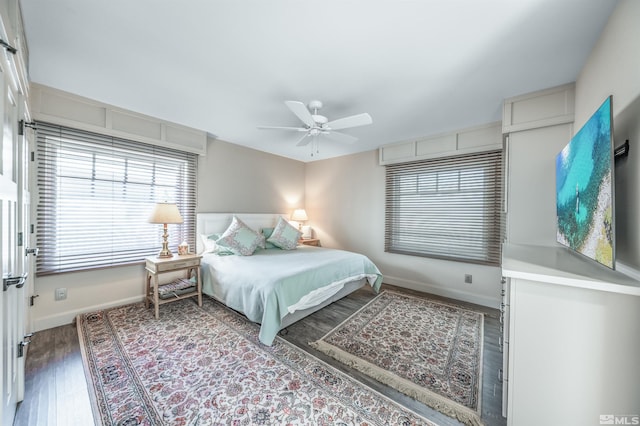 bedroom with ceiling fan and dark wood-type flooring