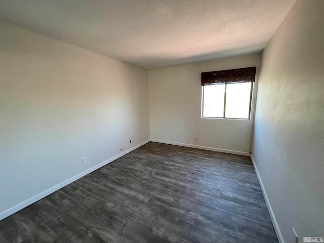 spare room with dark hardwood / wood-style floors