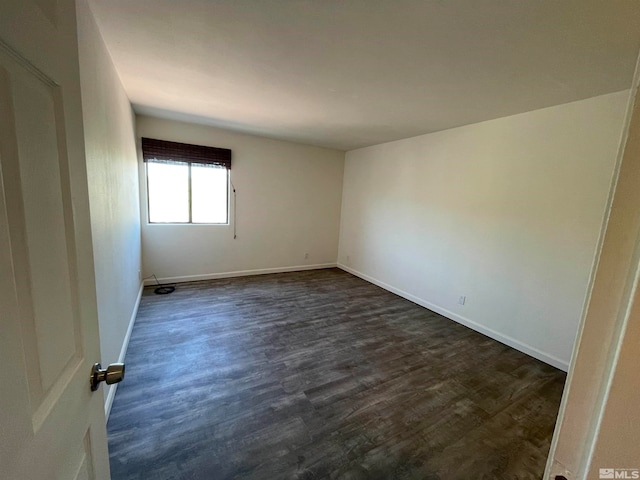 spare room with dark hardwood / wood-style floors