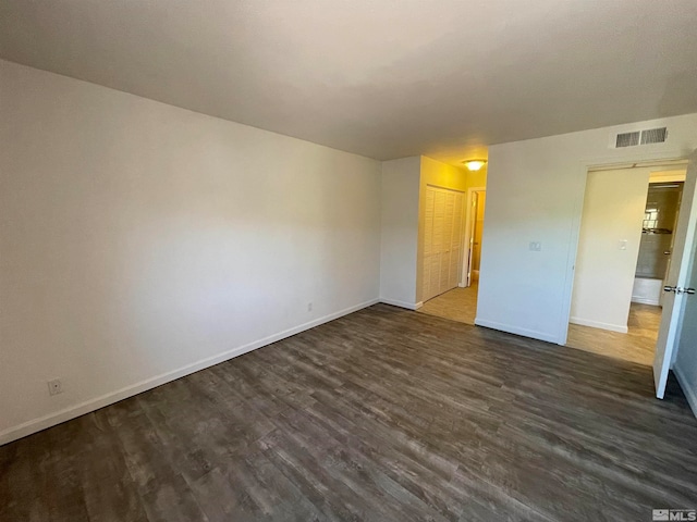 unfurnished bedroom with a closet and dark hardwood / wood-style flooring