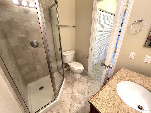 bathroom featuring tile patterned floors, walk in shower, vanity, and toilet