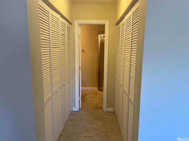 corridor featuring light tile patterned flooring