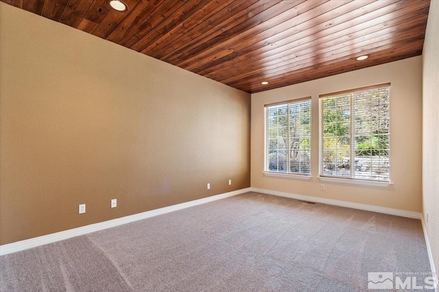 carpeted empty room featuring wooden ceiling