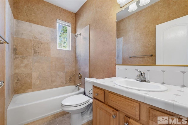 full bathroom with tile flooring, tiled shower / bath, oversized vanity, tasteful backsplash, and toilet