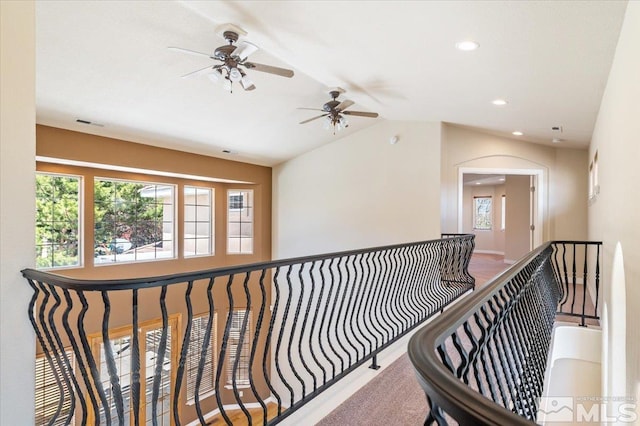 corridor with lofted ceiling and carpet flooring