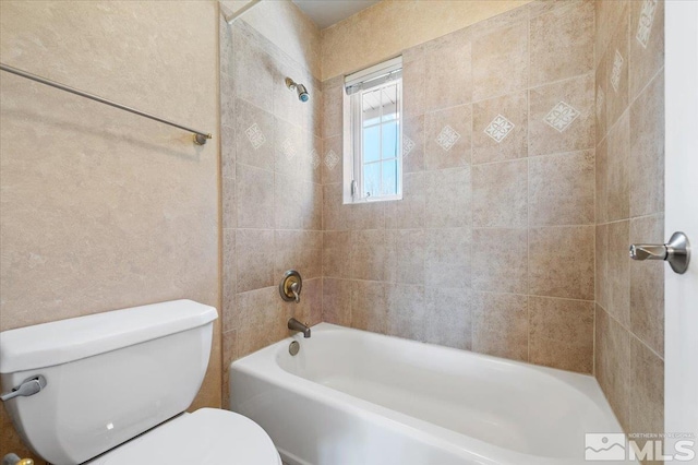 bathroom featuring tiled shower / bath and toilet