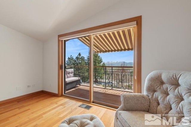 interior space featuring lofted ceiling and light hardwood / wood-style floors